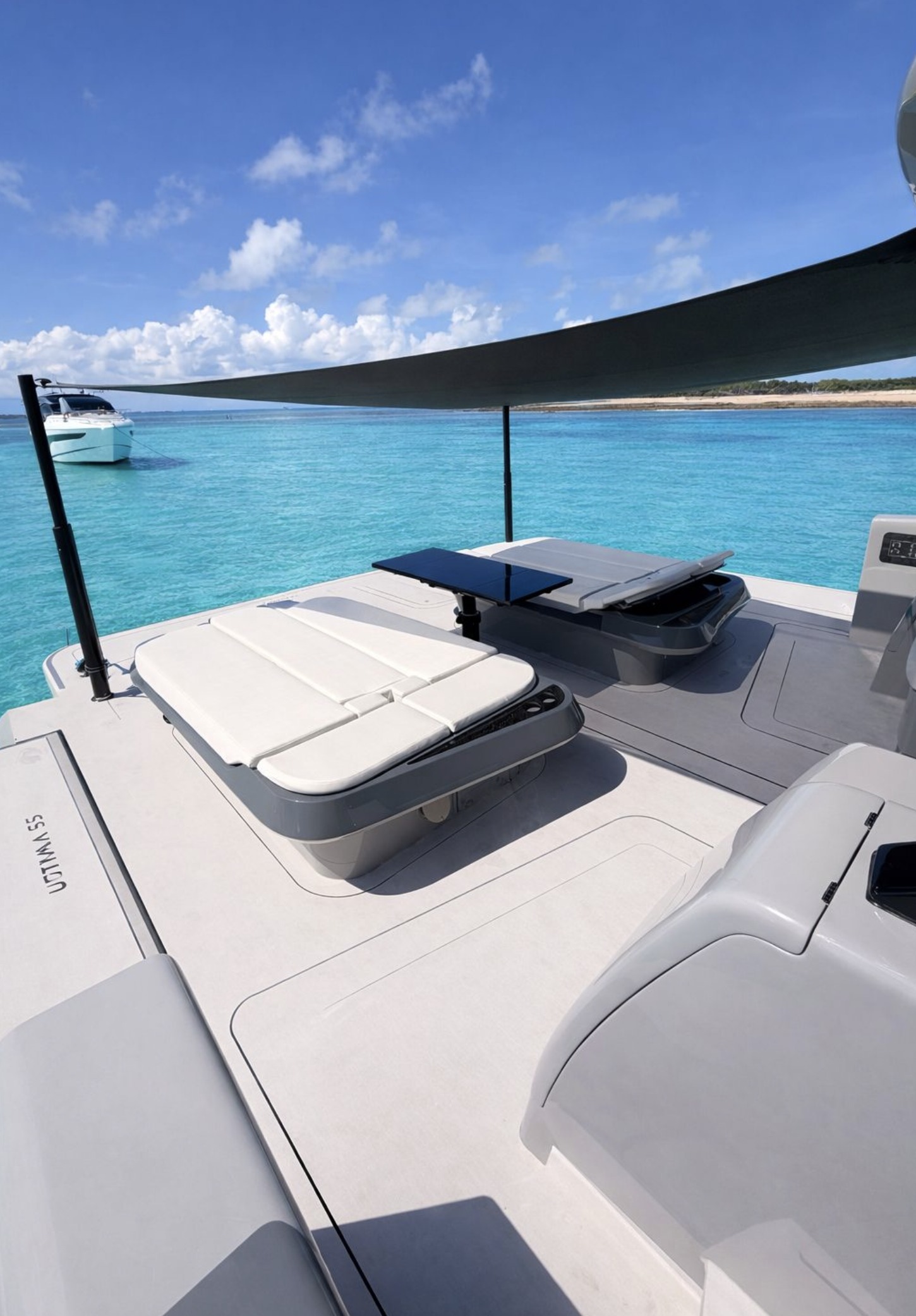 Cockpit daybeds and dining table under the aft shade sail